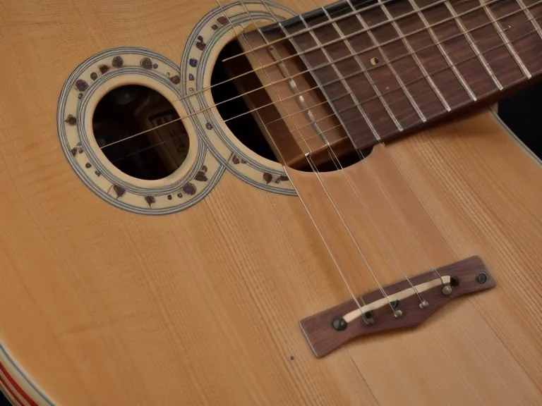 Diagramas de acordes de guitarra junto a una guitarra acústica de segunda mano, útiles para principiantes adultos